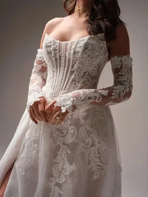 model is wearing an a-line wedding dress with matching sleeves