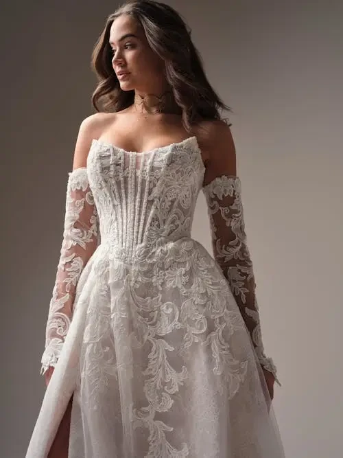 model is wearing an a-line wedding dress with matching sleeves