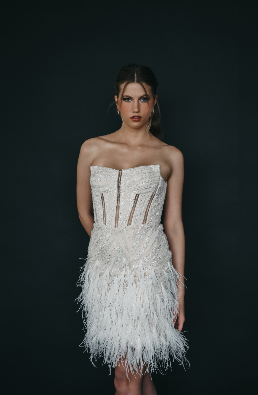 model is wearing a strapless mini bridal gown