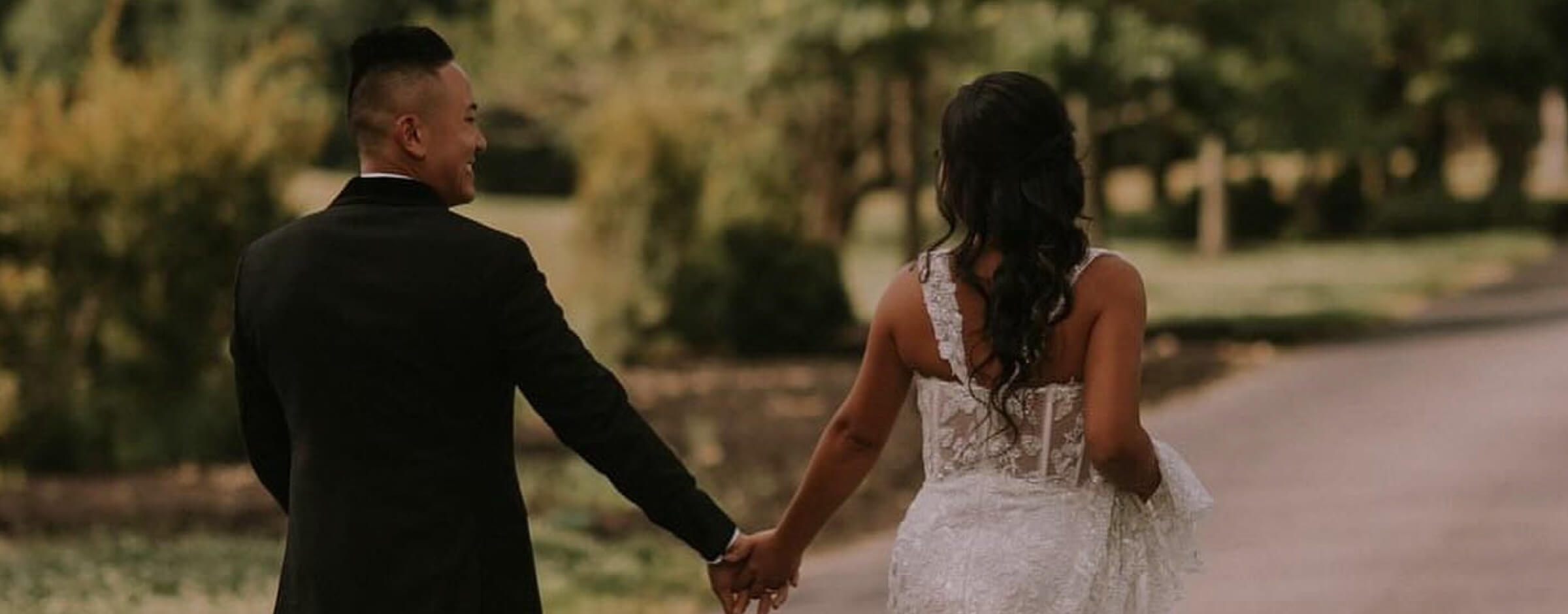 Сouple wearing a white gown and a black suit