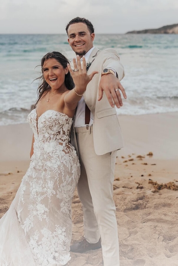 Сouple wearing a white gown and a white suit