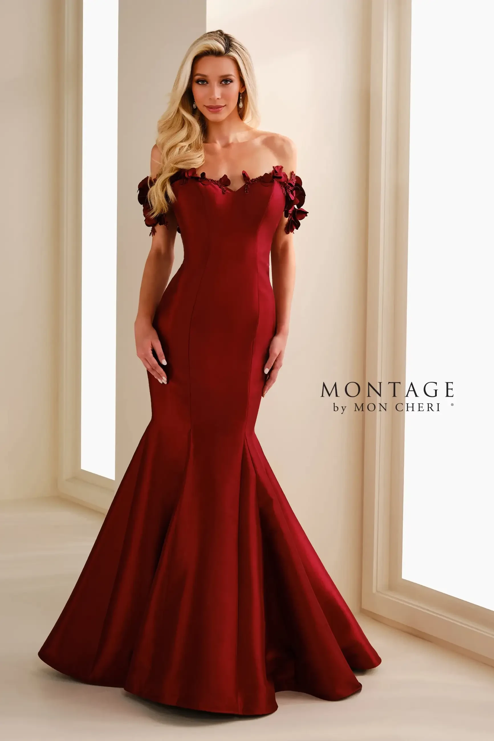 model is wearing a red off the shoulder fit and flare mothers dress